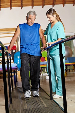 Physical Therapist helping patient walk